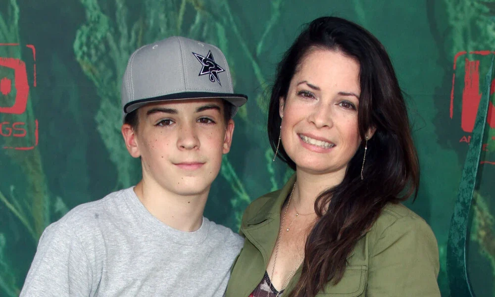 Riley Edward Donoho with his mother, Holly Marie Combs, smiling together at a public event.